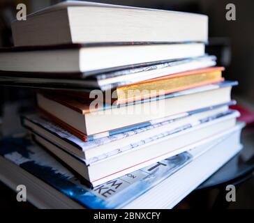 Stack of books on glass table Stock Photo