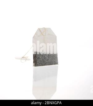A single string tea bag isolated on a white background. This is a Twinings moroccan mint bag. Stock Photo