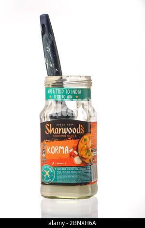 A Sharwoods cooking sauce pot used as a paint brush cleaner container as part of recycling use of products and glass.  isolated on a white background. Stock Photo