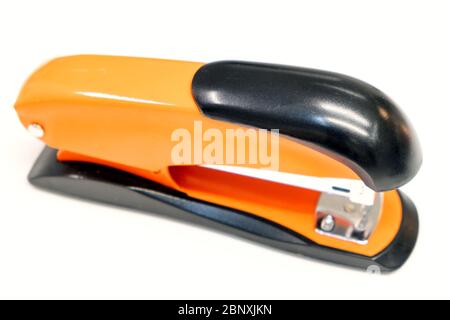 Orange Stapler on white background. Close up Stock Photo