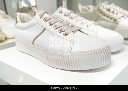 Pair of white sneaker on shelf. Close up Stock Photo