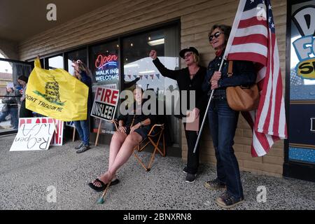 Vancouver, USA. 16th May, 2020. Kelly Carroll who officially opened her business, The Pet Biz, a luxury pet grooming operation in Vancouver, Wash., raises her fist in the air in front of supporters on May 16, 2020. The opening is a direct violation of Governor Jay Inslee's orders for non-essential business to remain closed at this time, but Kelly, who has already been operational for five days, insists she need to open to support her grand-daughters. (Photo by Alex Milan Tracy/Sipa USA) Credit: Sipa USA/Alamy Live News Stock Photo