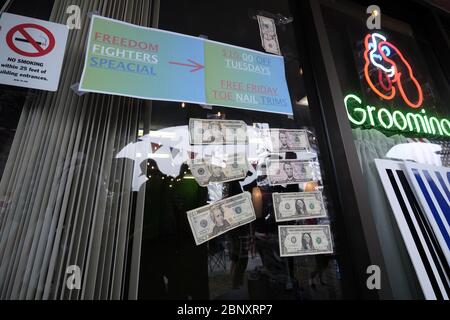 Vancouver, USA. 16th May, 2020. Money is pictured taped to the window of The Pet Biz, a luxury pet grooming operation in Vancouver, Wash., that was officially reopened today by owner Kelly Carroll on May 16, 2020. The opening is a direct violation of Governor Jay Inslee's orders for non-essential business to remain closed at this time, but Kelly, who has already been operational for five days, insists she need to open to support her grand-daughters. (Photo by Alex Milan Tracy/Sipa USA) Credit: Sipa USA/Alamy Live News Stock Photo