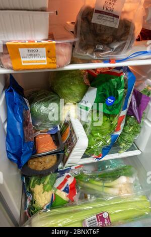 tightly packed small fridge with healthy food Stock Photo