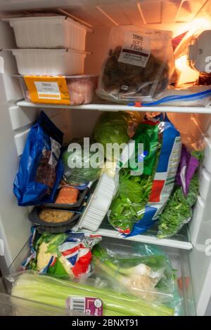 tightly packed small fridge with healthy food Stock Photo