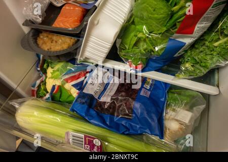 tightly packed small fridge with healthy food Stock Photo