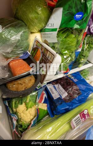 tightly packed small fridge with healthy food Stock Photo