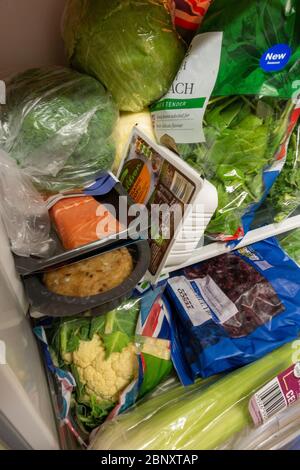 tightly packed small fridge with healthy food Stock Photo