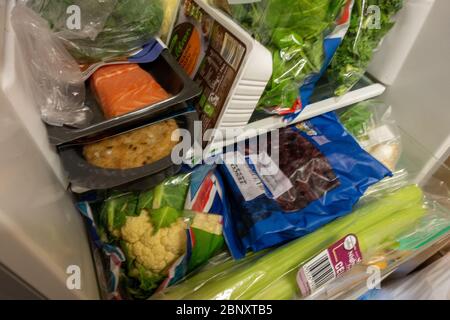 tightly packed small fridge with healthy food Stock Photo