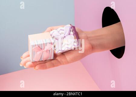 Close-up on hand showing two small gift boxes Stock Photo