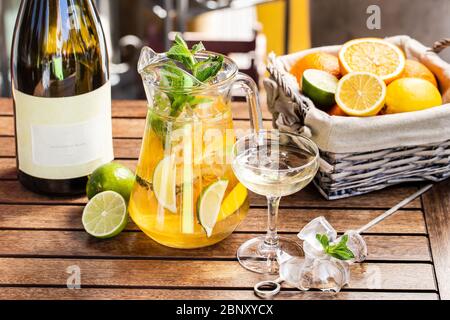 Fresh summer drink with citrus fruits and ice. Orange, lime, mint leaves Stock Photo