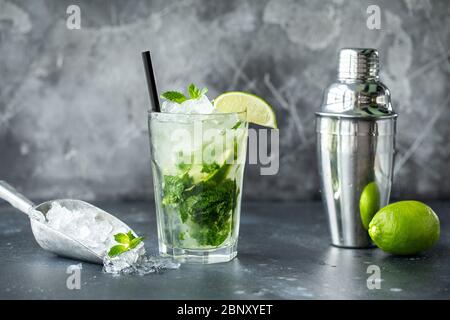 Caipirinha cocktail with lime, mint, ice. Drink making bar tools, shaker, ingredients Stock Photo