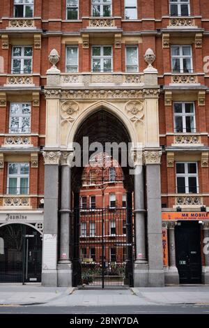 London, UK - 10 May 2020: Archway entrance into mansion apartment block Stock Photo