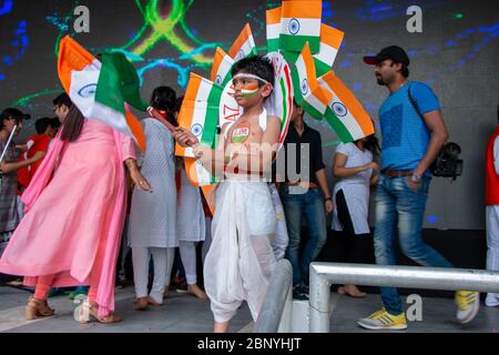 Indian kid waving the national flag at the stage. Stock Photo