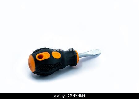A professional slotted Screwdriver with a Yellow-Black plastic handle. construction tool isolated on white background. Cruciform for repair and constr Stock Photo
