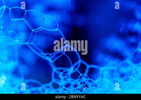 Abstract macro clean blue foam shot background of soap bubbles Stock Photo