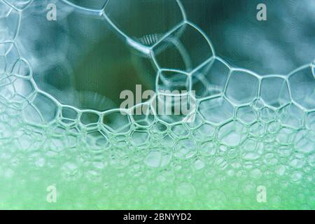 Abstract macro clean green foam shot background of soap bubbles Stock Photo