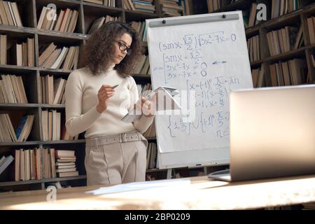 Hispanic woman teacher gives online math class, virtual remote teaching concept. Stock Photo