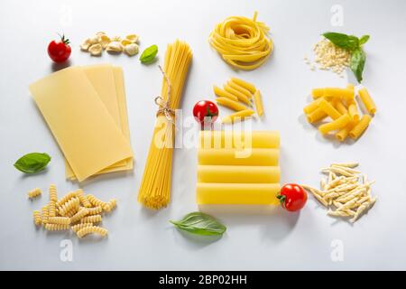 Various pasta and basil with cherry tomatoes Stock Photo