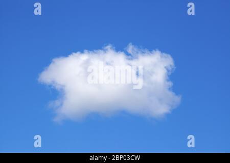 Single white cloud on a blue sky background. Stock Photo