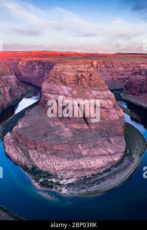 Horseshoe Bend at sunrise with the Colorado river flowing around through the canyon, Arizona Stock Photo