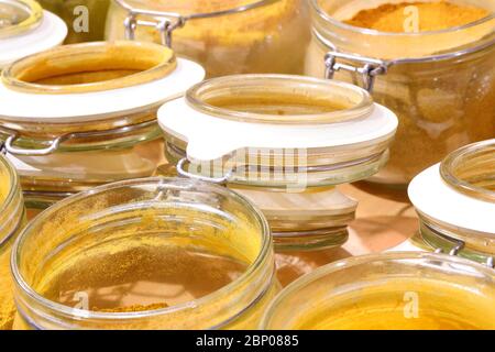 many spice jars and some with spicy curry for sale in the stall Stock Photo