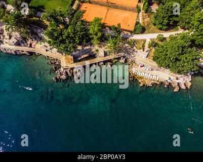 Beautiful panoramic view of Lovran village and its sea shore in Croatia. Top view photo taken on drone. Stock Photo