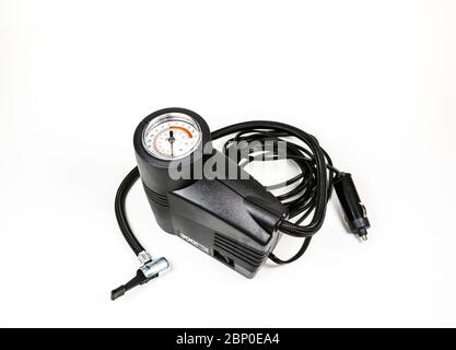 a compact inflation machine with gauge number on white background,for car,suv,bike and ball. Stock Photo