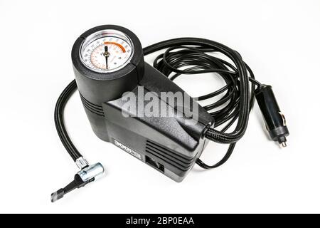 a compact inflation machine with gauge number on white background,for car,suv,bike and ball. Stock Photo