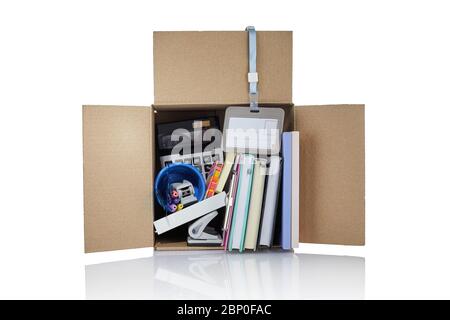Dismissal. Box with office supplies. Cardboard box full of office stuff on white background Stock Photo