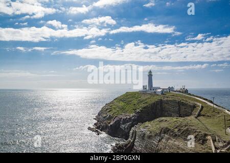 Lighthouse on coastal island near Holyhead on Anglesey in beautiful North Wales. Sunny day. Stock Photo