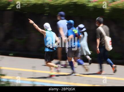 Tokyo, Japan. 17th May, 2020. Joggers train at a park in Tokyo on Sunday, May 17, 2020. Japanese government extended a state of emergency for Tokyo Metropolitan area on May 14. Credit: Yoshio Tsunoda/AFLO/Alamy Live News