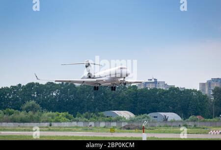 Business jet on final approach before landing on the runway Stock Photo