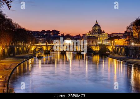 Sunset over the St. Peters Basilica and the river Tiber in Rome Stock Photo
