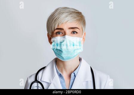 Health and medicine concept. Portrait of friendly therapist in protective mask, close up Stock Photo