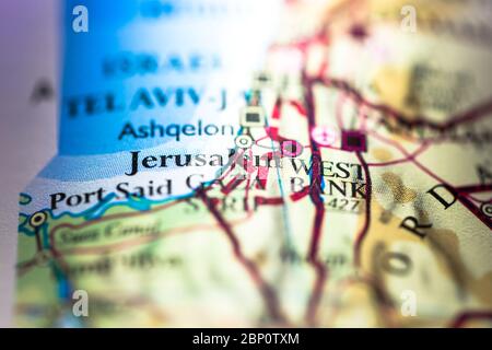 Shallow depth of field focus on geographical map location of Jerusalem city in Israel Palestinian Asia continent on atlas Stock Photo