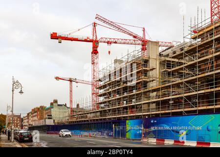 Construction building cranes at redevelopment of "ESB" buildings in city centre with signage "building a better future". Dublin, Ireland Stock Photo