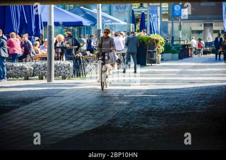 Woman on bicycle enters a tunnel at the nearby World Trade Center in Amsterdam Stock Photo