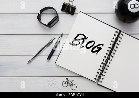 Smartwatch and notebook with word BLOG on office desk, copy space. Creative collage Stock Photo