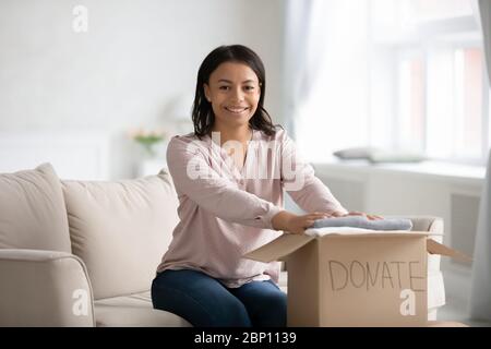 African woman prepare donation clothes for poor and needy people Stock Photo