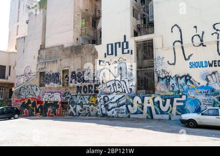 Walls with graffitis and old car in Athens, Greece. August 2019 Stock Photo