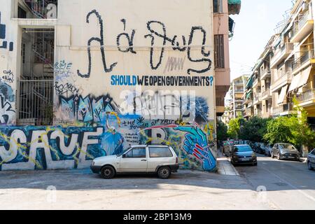 Wall with graffitis and old car in Athens, Greece. August 2019 Stock Photo