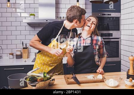 Young cheerful couple preparing food together Stock Photo