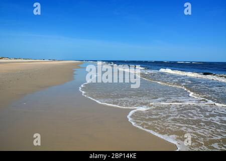 Looking down the wide open shoreline in Nags Head on the Outer Banks of North Carolina. Stock Photo