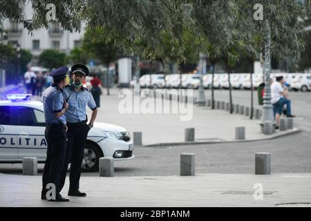 Bucharest, Romania - 16 May 2020: Police officers on Calea Victoriei on the second day of alert caused by the COVID-19 pandemic, in Bucharest. Stock Photo