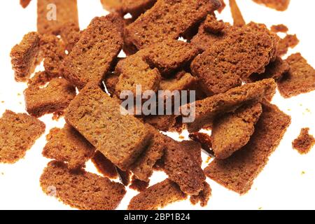 rye crackers, small dried pieces of bread with spices, delicious fast food isolated on white background Stock Photo