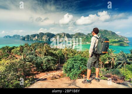 Man tourist with backpack on the mountain see the beautiful nature landscape of the sea, adventure on vacation during travel Asia Stock Photo