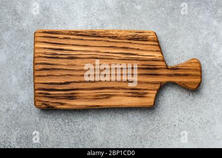 Wooden cutting board isolated on concrete background, top view Stock Photo