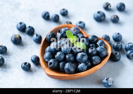 Fresh juicy blueberries in heart shaped wooden bowl. Superfood berries Stock Photo