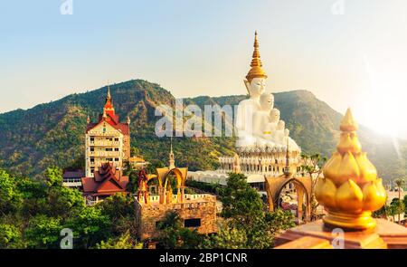 Amazing Thailand Temple Wat Phra Thart Pha Sorn Kaew in Asia with big Buddha statue on background scenery dramatic cloudy sky at sunset. Beautiful Lan Stock Photo